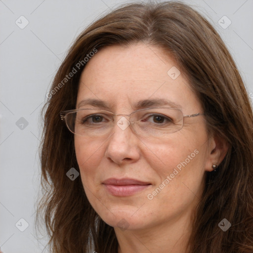 Joyful white adult female with long  brown hair and brown eyes