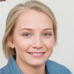 Joyful white young-adult female with medium  brown hair and blue eyes