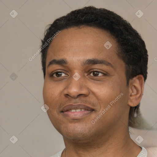 Joyful black young-adult male with short  black hair and brown eyes