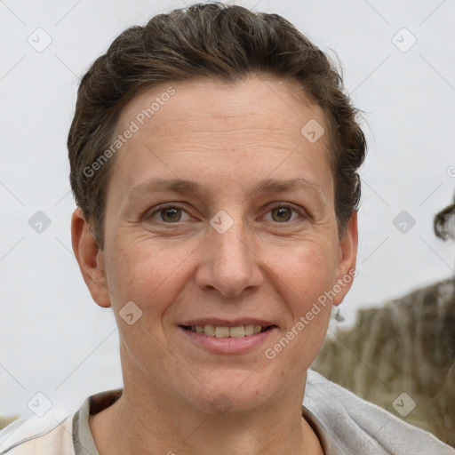 Joyful white adult female with short  brown hair and grey eyes