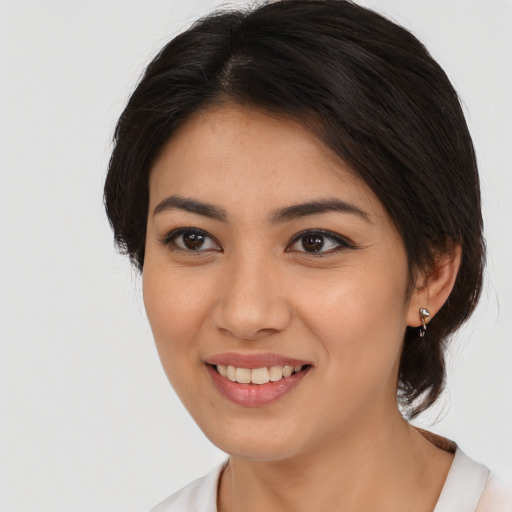 Joyful asian young-adult female with medium  brown hair and brown eyes