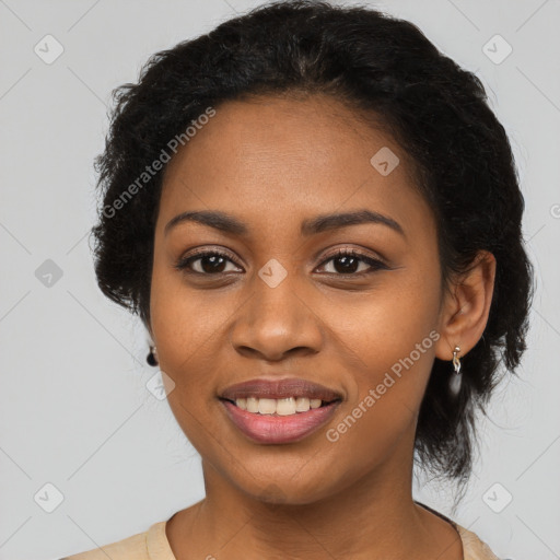 Joyful black young-adult female with long  black hair and brown eyes