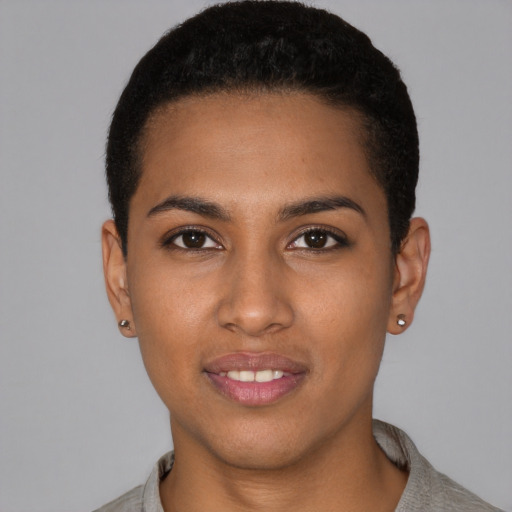 Joyful black young-adult female with short  black hair and brown eyes