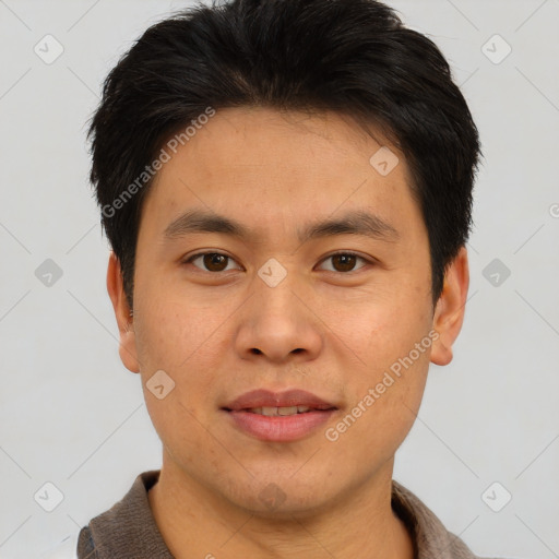 Joyful asian young-adult male with short  brown hair and brown eyes