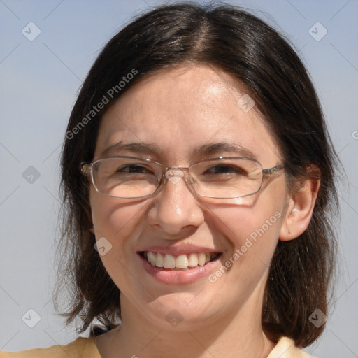 Joyful white adult female with medium  brown hair and blue eyes