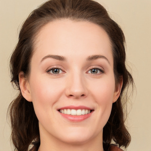 Joyful white young-adult female with long  brown hair and green eyes