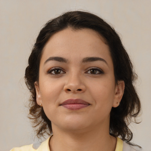 Joyful latino young-adult female with medium  brown hair and brown eyes