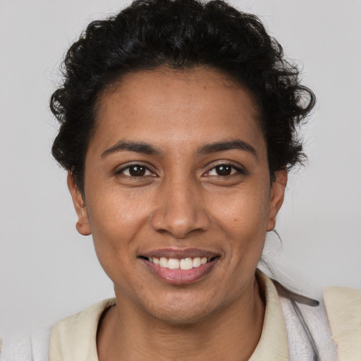 Joyful latino young-adult female with short  brown hair and brown eyes