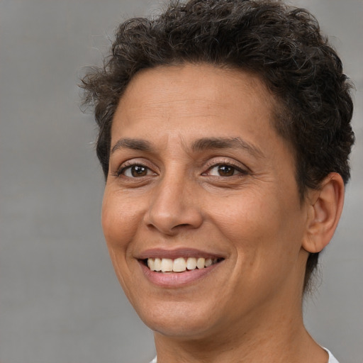Joyful white adult female with short  brown hair and brown eyes