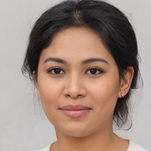 Joyful asian young-adult female with medium  brown hair and brown eyes