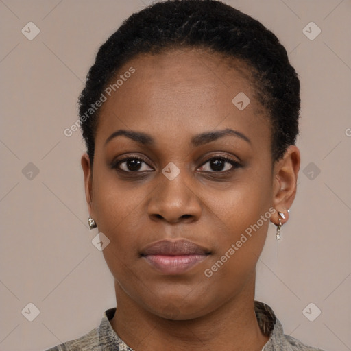 Joyful black young-adult female with short  black hair and brown eyes