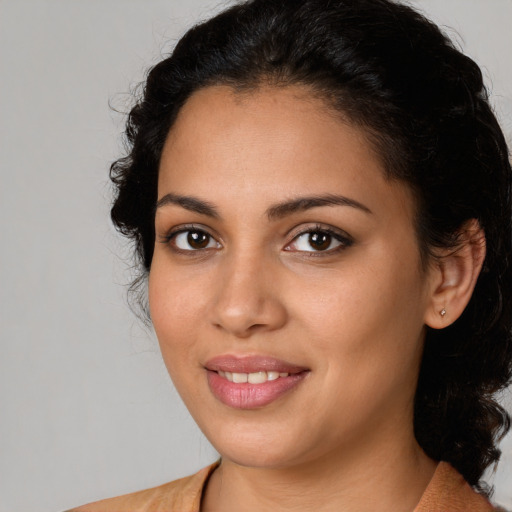 Joyful latino young-adult female with medium  brown hair and brown eyes