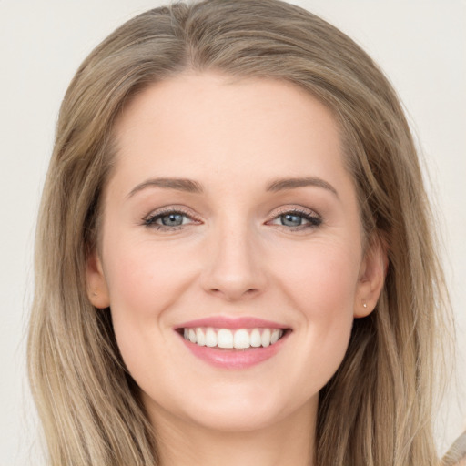 Joyful white young-adult female with long  brown hair and grey eyes