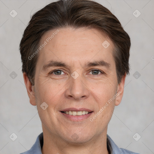 Joyful white adult male with short  brown hair and grey eyes