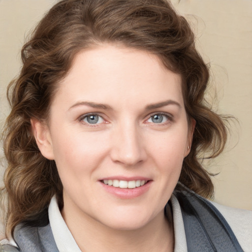 Joyful white young-adult female with medium  brown hair and blue eyes