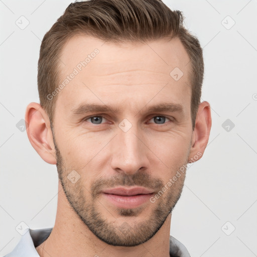 Joyful white young-adult male with short  brown hair and grey eyes