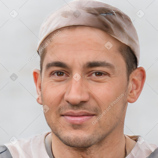 Joyful white adult male with short  brown hair and brown eyes