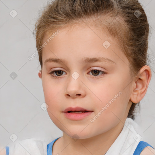 Joyful white child female with short  brown hair and brown eyes