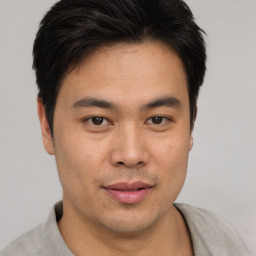 Joyful asian young-adult male with short  brown hair and brown eyes