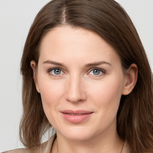 Joyful white young-adult female with long  brown hair and grey eyes