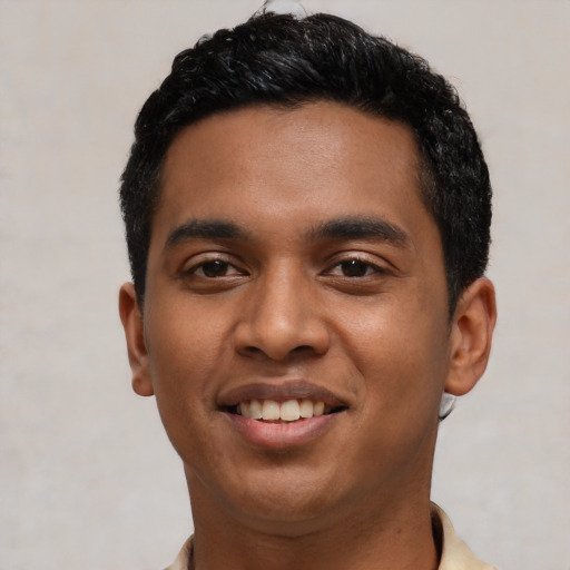 Joyful latino young-adult male with short  black hair and brown eyes