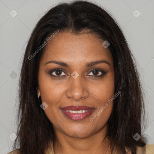 Joyful black young-adult female with long  brown hair and brown eyes