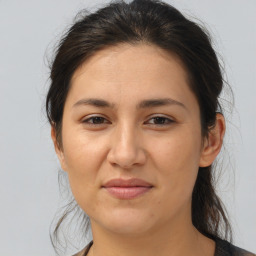 Joyful white young-adult female with medium  brown hair and brown eyes