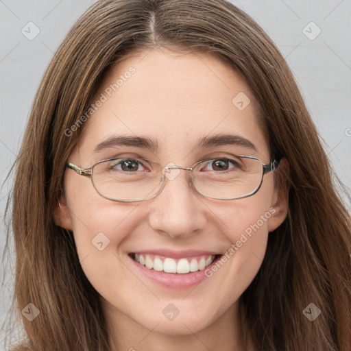 Joyful white young-adult female with long  brown hair and green eyes