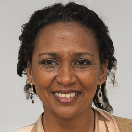 Joyful latino adult female with medium  brown hair and brown eyes