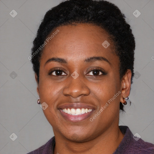 Joyful black young-adult female with short  black hair and brown eyes