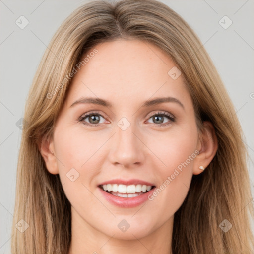 Joyful white young-adult female with long  brown hair and brown eyes