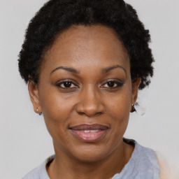 Joyful black adult female with short  brown hair and brown eyes