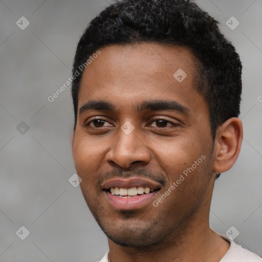 Joyful black young-adult male with short  black hair and brown eyes