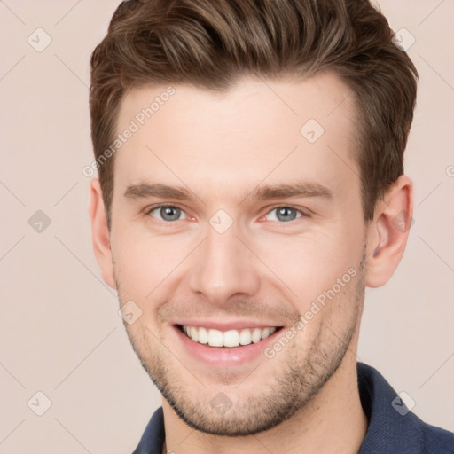 Joyful white young-adult male with short  brown hair and grey eyes