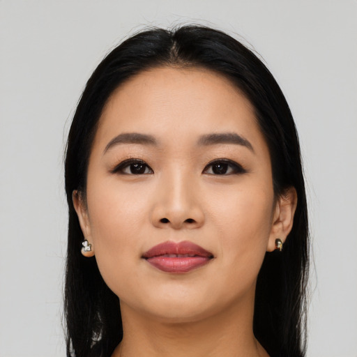 Joyful asian young-adult female with long  black hair and brown eyes