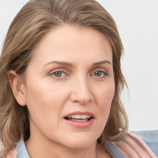 Joyful white young-adult female with medium  brown hair and blue eyes