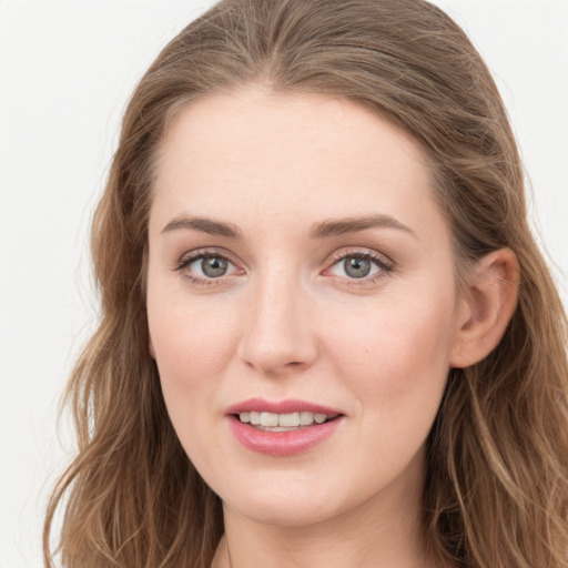 Joyful white young-adult female with long  brown hair and blue eyes