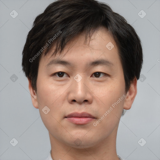 Joyful asian young-adult male with short  brown hair and brown eyes