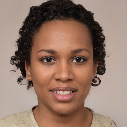 Joyful black young-adult female with short  brown hair and brown eyes