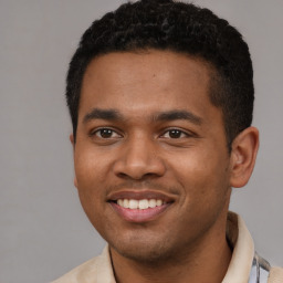 Joyful latino young-adult male with short  black hair and brown eyes