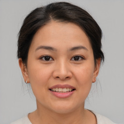 Joyful asian young-adult female with medium  brown hair and brown eyes