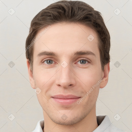 Joyful white young-adult male with short  brown hair and grey eyes