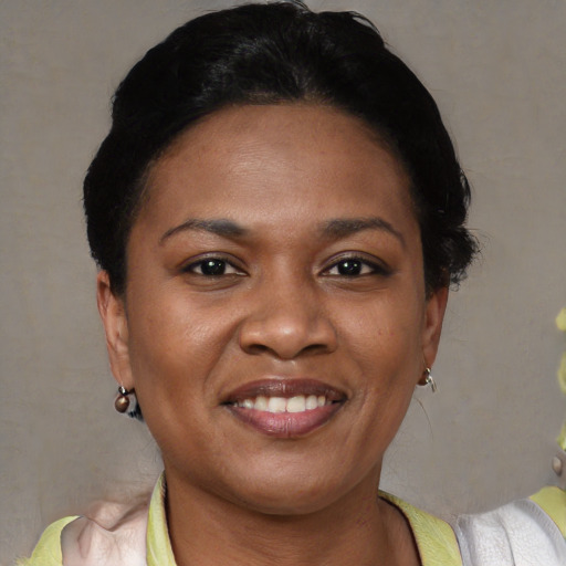 Joyful black young-adult female with short  black hair and brown eyes