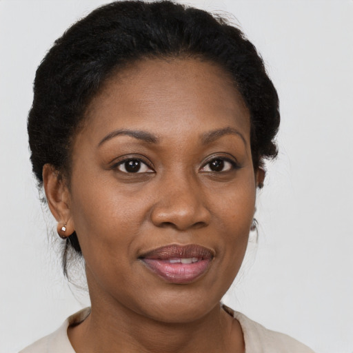 Joyful black adult female with short  brown hair and brown eyes