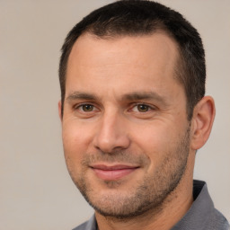 Joyful white adult male with short  brown hair and brown eyes