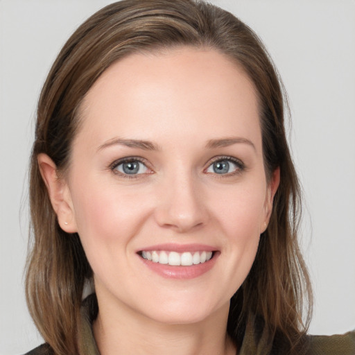 Joyful white young-adult female with long  brown hair and grey eyes