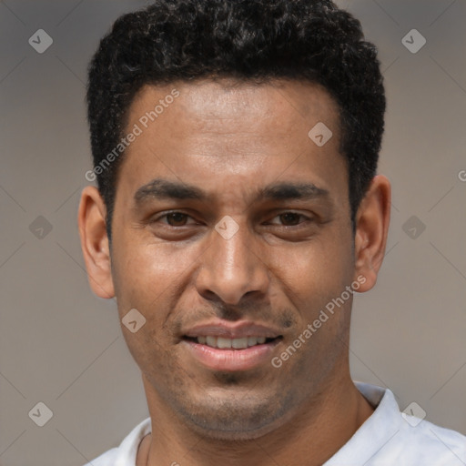 Joyful latino young-adult male with short  black hair and brown eyes