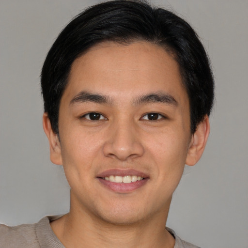 Joyful asian young-adult male with short  brown hair and brown eyes