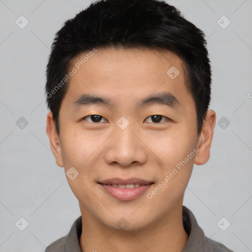 Joyful asian young-adult male with short  black hair and brown eyes