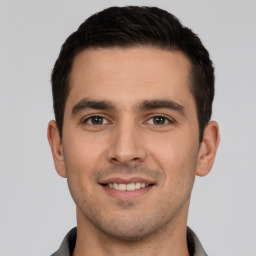 Joyful white young-adult male with short  brown hair and brown eyes